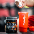 Scitec Nutrition 100% Creatine Monohydrate supplement with a shaker, promoting muscle growth and performance.